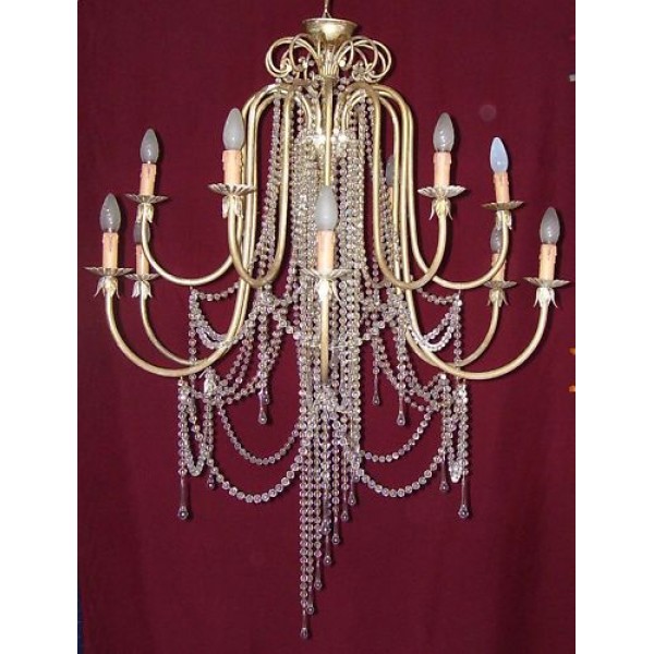 Wrought Iron Chandelier. Dimensions cm size 100 approx . Gold color . 12 Lights candles . 283